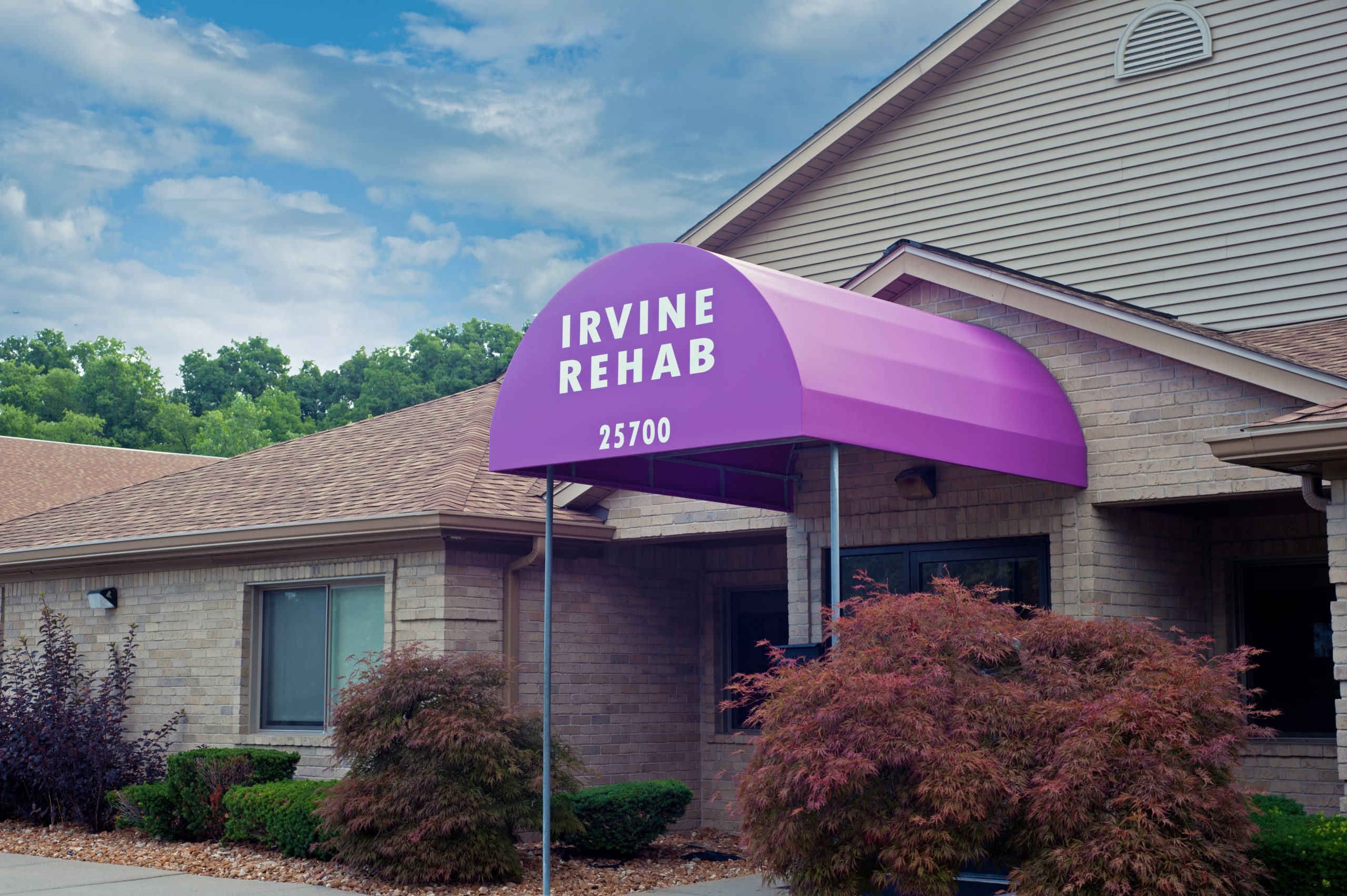A purple tent is in front of the entrance to an office.